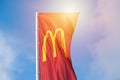McDonalds red flag with logo of fast food restaurant branch, roadside flow in wind flag with logo