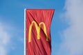 McDonalds red flag with logo of fast food restaurant branch, roadside flow in wind flag with logo
