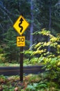 McKenzie Pass road sign to drive slow due to curves Royalty Free Stock Photo