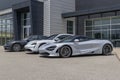 McLaren and Porsche sports cars on display at a dealership. Both McLaren and Porsche sportscars are in high demand