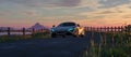 McLaren 720S Luxury Sports Car on a road with rocky mountain landscape in background. 3d Rendering
