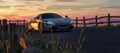 McLaren 720S Luxury Sports Car on a road with rocky mountain landscape in background. 3d Rendering