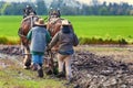 Two women guide a plow pulled by draft horses Royalty Free Stock Photo