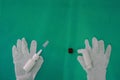 MDI and nasal spray with gloves on green surgery background in allergy or asthma medical healthcare concept with copy space