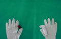 MDI spray with gloves on green surgery background in allergy or asthma medical healthcare concept with copy space