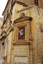 Mdina, Malta, July 2014. The ancient depiction of Saint Nicholas on a historic building in the city center.