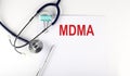 MDMA text written on paper with a stethoscope. Medical concept