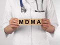 MDMA therapy acronym, medical word on wood cubes