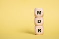 MDR Acronym on wooden blocks isolated on Yellow background