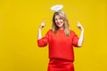 This is me angel! Portrait of proud adorable young woman with bright makeup in red casual clothes, isolated on yellow background