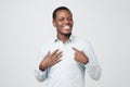 Portrait of proud handsome african man standing, looking at camera and pointing himself. Royalty Free Stock Photo