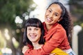 Me and my bestie, livin young, wild and free. Shot of two young women enjoying a piggyback ride outdoors. Royalty Free Stock Photo