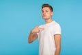 This is me! Portrait of conceited man in t-shirt pointing himself and looking with arrogant selfish expression Royalty Free Stock Photo