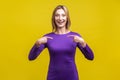 This is me! Portrait of joyous winner, excited businesswoman pointing at herself. on yellow background
