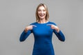 This is me! Portrait of joyous winner, excited businesswoman pointing at herself. isolated on gray background Royalty Free Stock Photo