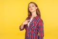 This is me! Portrait of selfish haughty ginger girl in checkered shirt pointing at herself, looking at camera with arrogance and