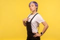 This is me! Portrait of selfish hipster woman pointing herself, feeling self-important and proud. yellow background, studio shot