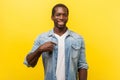 This is me. Portrait of successful positive young man pointing at himself, grinning happily at camera. indoor studio shot isolated