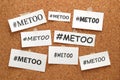 Me Too hashtag word on white papers on bulletin board. Me Too social movement hashtag against sexual assault and harassment. Royalty Free Stock Photo