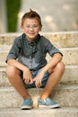 Me young boy sitting on stairs in park Royalty Free Stock Photo
