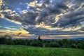 Meadow with dramatic clouds at background.