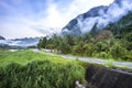 Meadow,lake,mountains on cloudy blue sky background Royalty Free Stock Photo