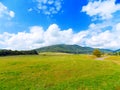 Meadow, road, hills and sky Royalty Free Stock Photo
