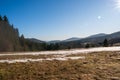 Meadows at the end of winter with snow and mountains in the background, beskydy czech Royalty Free Stock Photo