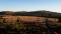 Meadows on a mountain ridge with pole marked walking path and a transmitter on a hill in the background Royalty Free Stock Photo