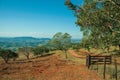 Meadows and trees in a green valley with farm gate Royalty Free Stock Photo