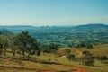 Meadows and trees in a green valley with hilly landscape