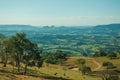 Meadows and trees in a green valley with hilly landscape