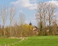 Meadows with trees and little church in the Wallonian countryside