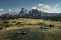 Meadows with wooden cabins at Alpe di Siusi during summer with view to mountains of Plattkofel and Langkofel in the Dolomite Alps Royalty Free Stock Photo