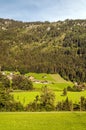 Meadows with wooden houses Royalty Free Stock Photo