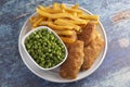 A Meal of Beer Battered Fish Chips and Peas Royalty Free Stock Photo