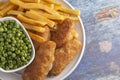 A Meal of Beer Battered Fish Chips and Peas Royalty Free Stock Photo