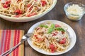 A meal with chicken, basil and tomato linguine