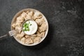 Meal of dumplings and sour cream on black stone table Royalty Free Stock Photo