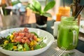 A meal of Mango and Ahi Tuna poke salad and frech green juice Royalty Free Stock Photo