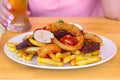 Meal for the Munich Oktoberfest with sausages, potato, cabbage and pretzels served with beer over stone backround. Selective focus Royalty Free Stock Photo