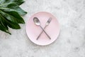Meal is over. Ask for the bill. Plate with crossed spoon and fork on grey stone table top view copyspace Royalty Free Stock Photo