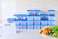 A meal plan for a week on a white table among set of plastic containers for food and food. Proper nutrition during the week Royalty Free Stock Photo