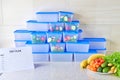 A meal plan for a week on a white table among set of plastic containers for food and food. Proper nutrition during the week Royalty Free Stock Photo