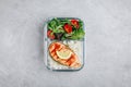 Meal prep containers with salmon and rice, green mix salad with tomatoes. Royalty Free Stock Photo