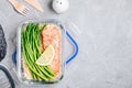 Meal prep lunch box container with baked salmon fish, rice, green asparagus