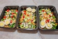 Meal prep protean salad in black meal prep containers