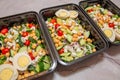 Meal prep protean salad in black meal prep containers