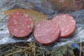 a meal of three pieces of red salami sausage and a piece of bread Royalty Free Stock Photo