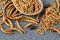 Meal worms, larvae of Tenebrio molitor and beetle closeup on granite table Royalty Free Stock Photo